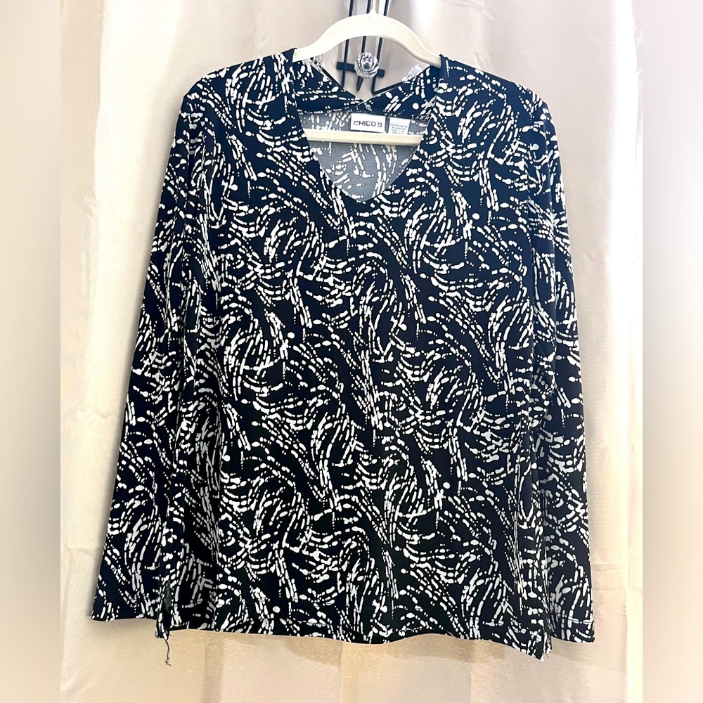 Chico’s size 2 black and white v neck knit top. Long sleeve.